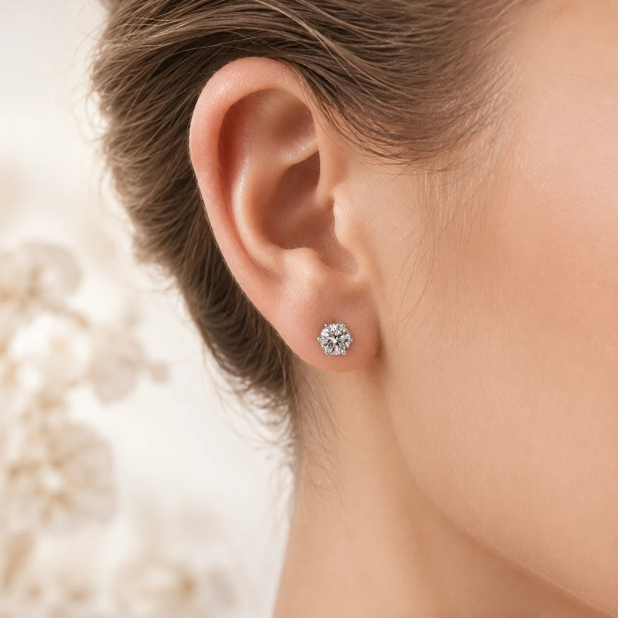 Six-prong moissanite stud worn on a model's ear