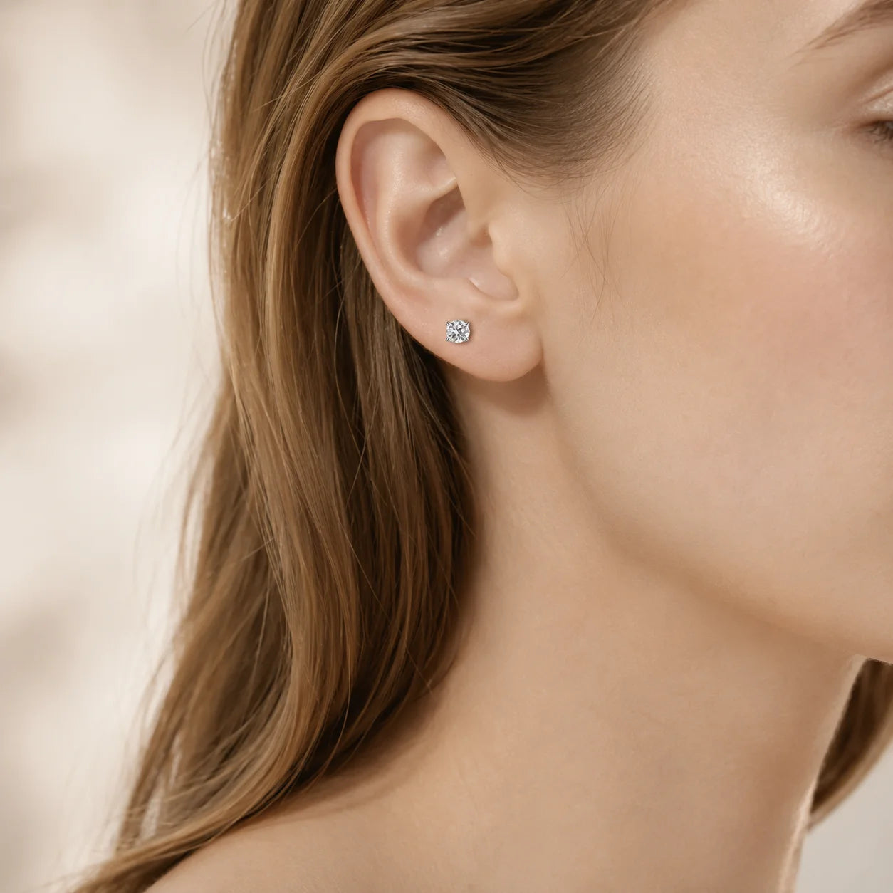 Four-prong moissanite stud worn on a model's ear
