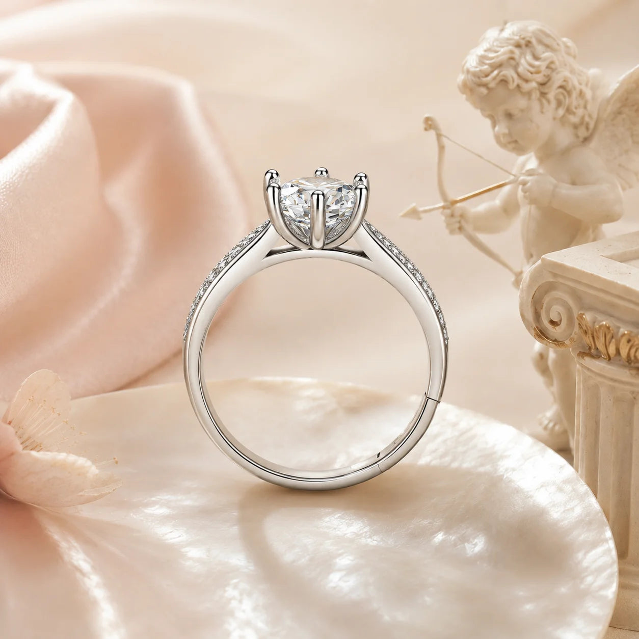 SENTO Eros Aile moissanite ring worn on model hand close-up blush silk cupid background