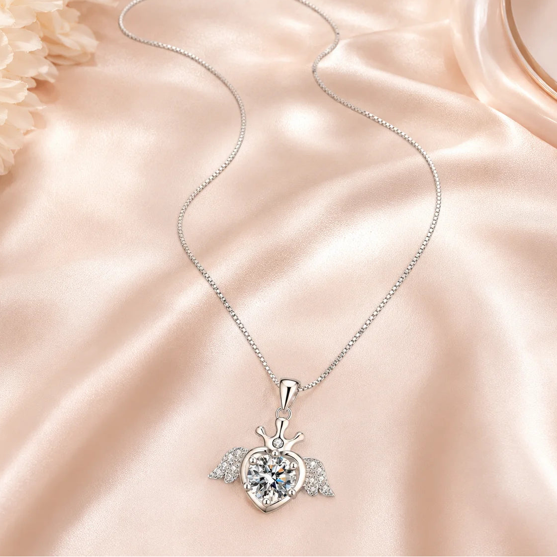 SENTO Eros Seraph winged crown heart moissanite necklace on blush silk lifestyle editorial