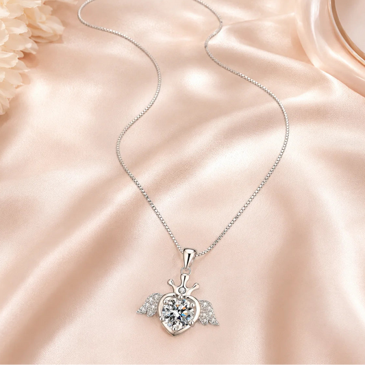 SENTO Eros Seraph winged crown heart moissanite necklace on blush silk lifestyle editorial