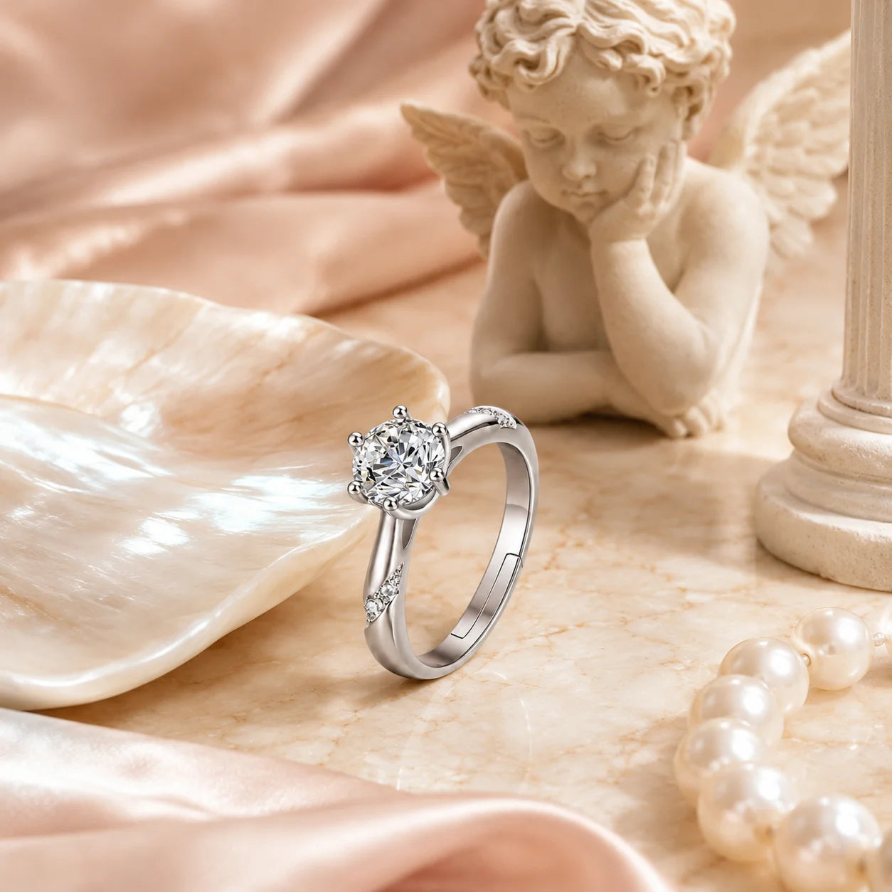 Six-prong moissanite ring beside a stone sculpture