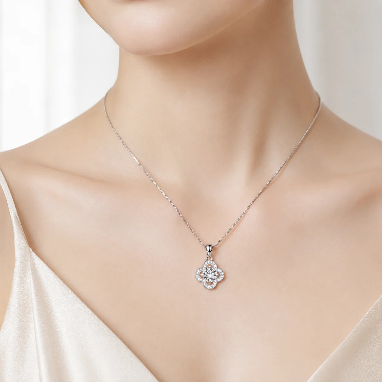 Four-petal moissanite pendant necklace worn at the collarbone