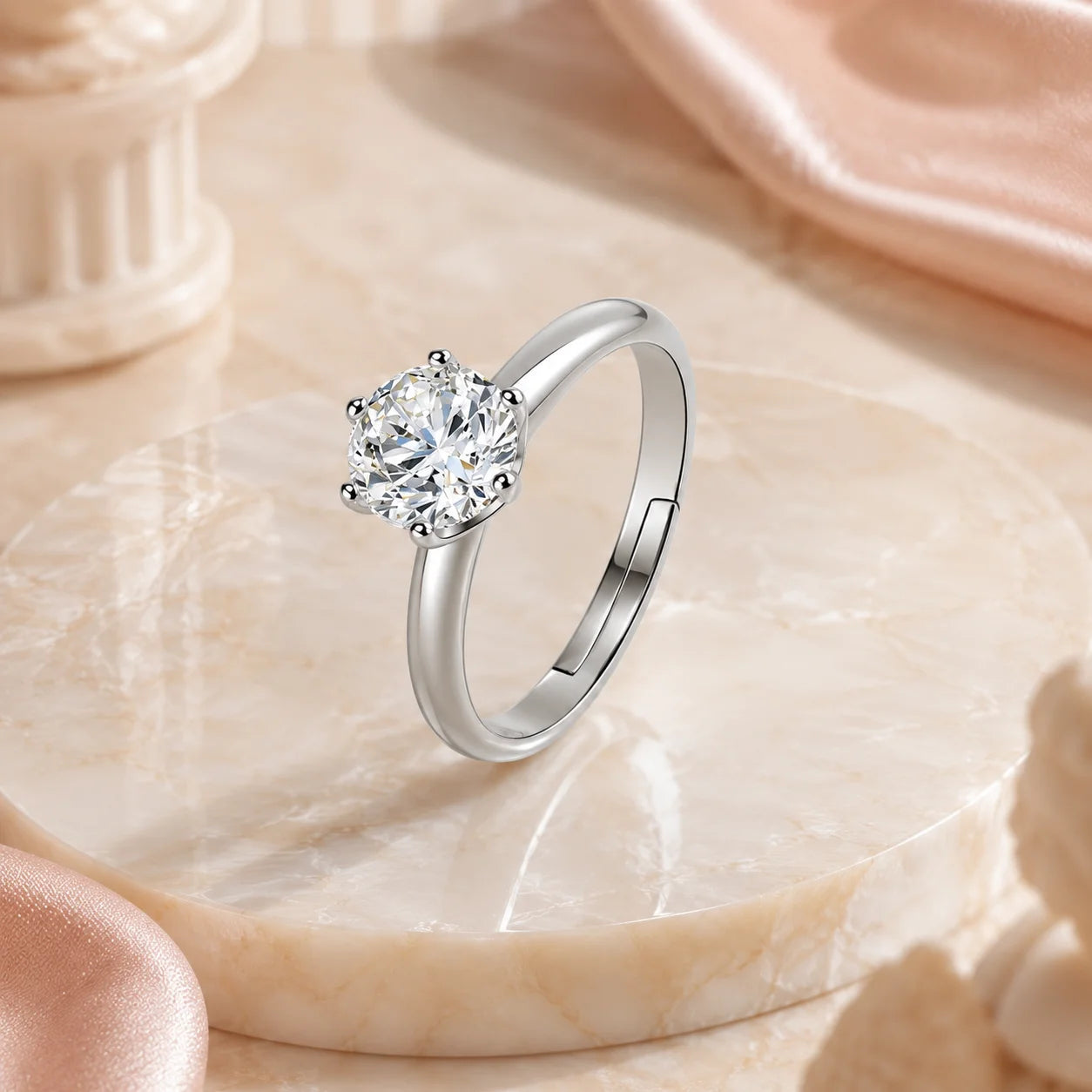 Six-prong moissanite solitaire ring on a marble platform