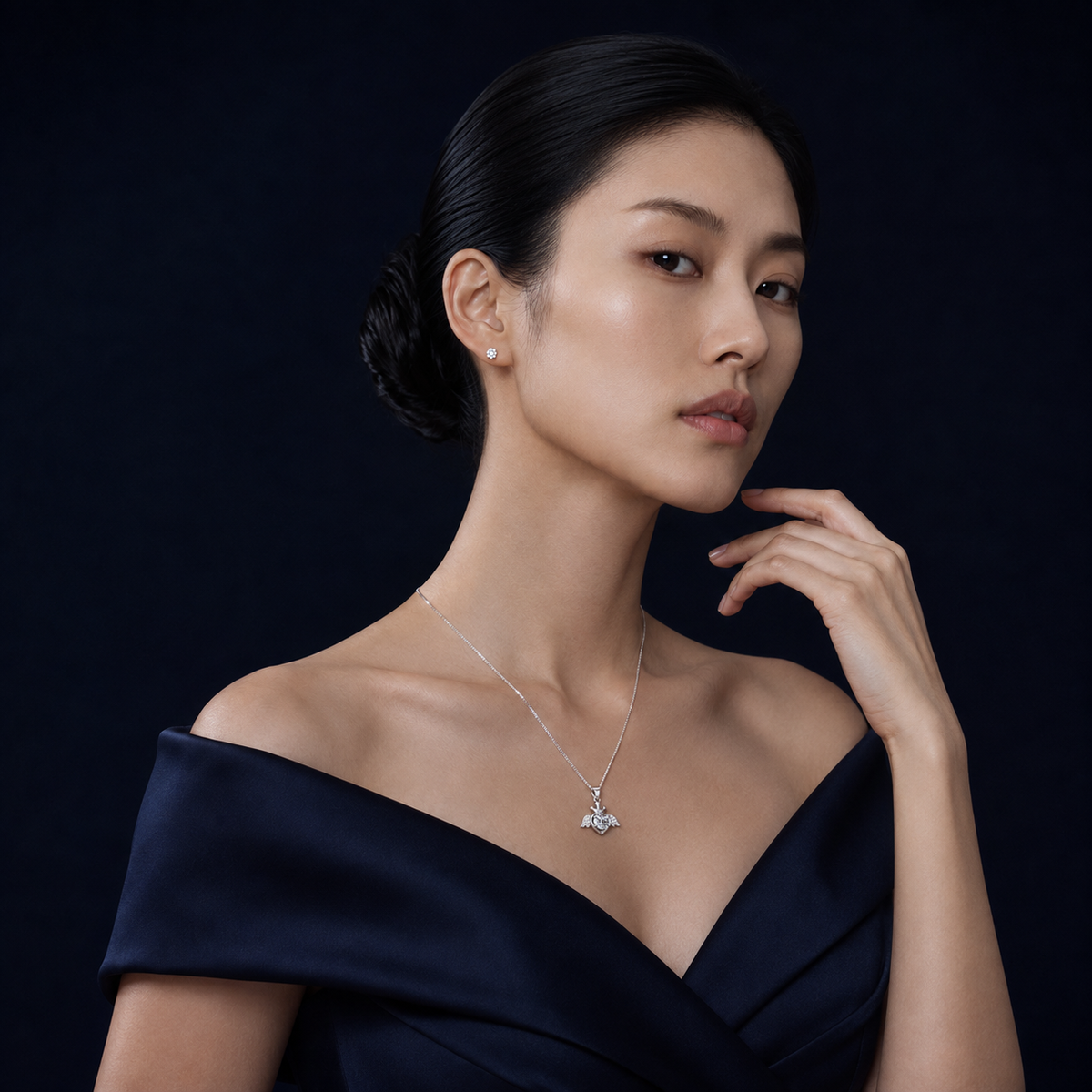 Model wearing Plume winged crown heart moissanite pendant necklace