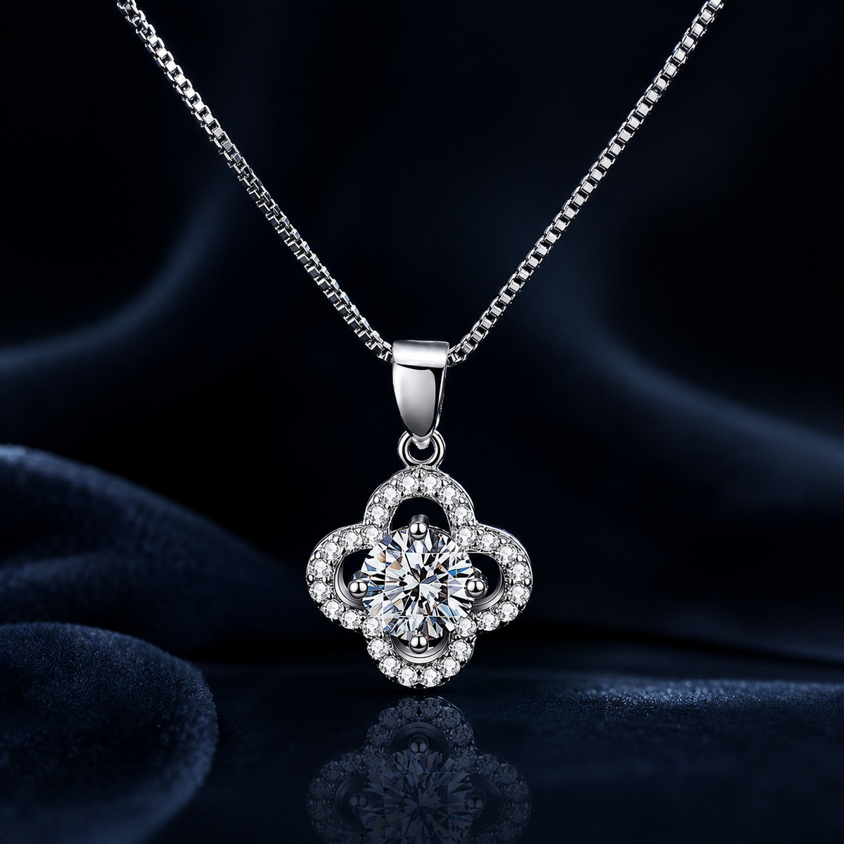 Close-up of Rosette four-petal halo moissanite pendant and box chain